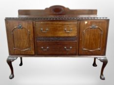 An early 20th century mahogany sideboard on claw and ball feet,