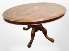 A Victorian mahogany oval dining table on carved pedestal support,