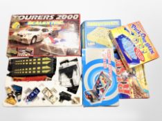 A box containing Scalextric racing set and other board games, pinball machine.