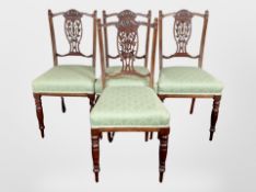 A set of four Victorian carved walnut salon chairs