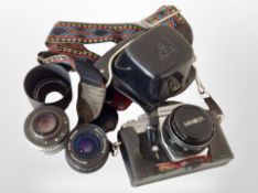 A Praktica MTL3 camera and several lenses.