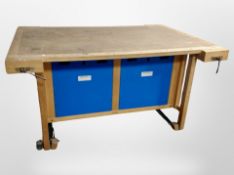 A Danish Lervad work bench fitted four vices and cabinets beneath,