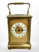 A French brass-cased carriage clock, enamel dial and platform escapement, striking on a gong,