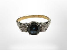 An 18ct yellow gold sapphire and two stone diamond ring, size J/K.