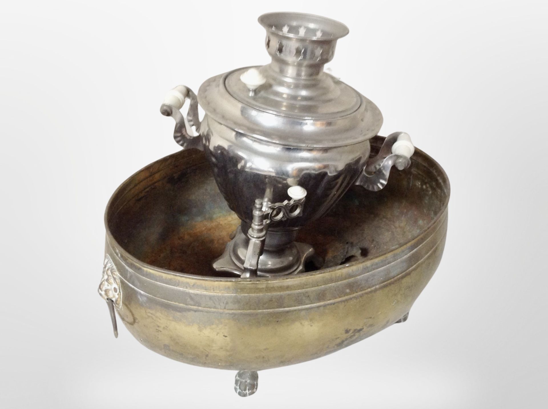 A 19th century brass oval planter with lion mask handles, together with a chrome-plated samovar.