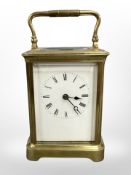 A brass-cased carriage clock, white dial with Roman numerals, platform escapement,
