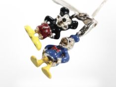 Two enameled silver Mickey Mouse and Donald Duck charms with silver catches.
