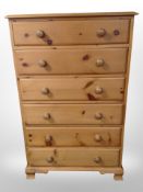 A contemporary pine six drawer chest,
