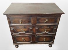 A 17th century style oak four drawer chest,