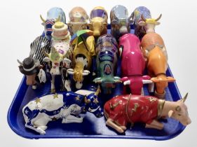 Thirteen Cow Parade figures.