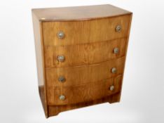 A mid 20th century burr walnut veneered bowfront four drawer chest,