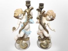 A pair of Italian resin cherub candlesticks, height 28cm.
