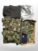 A box containing DPM clothing and men's tailored black trousers.