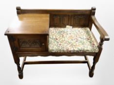 An oak linen fold telephone seat,