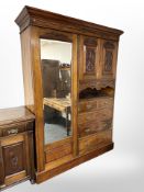 A Victorian carved walnut compactum mirror door wardrobe,