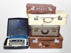 Four vintage luggage cases and a Safari typewriter in box.
