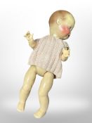 A 20th-century bisque-headed doll.