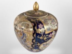 An early 20th-century Japanese earthenware export lidded vase, height 17cm.