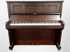 A Kemble mahogany-cased upright overstrung piano, 145cm x 60cm x 128cm.