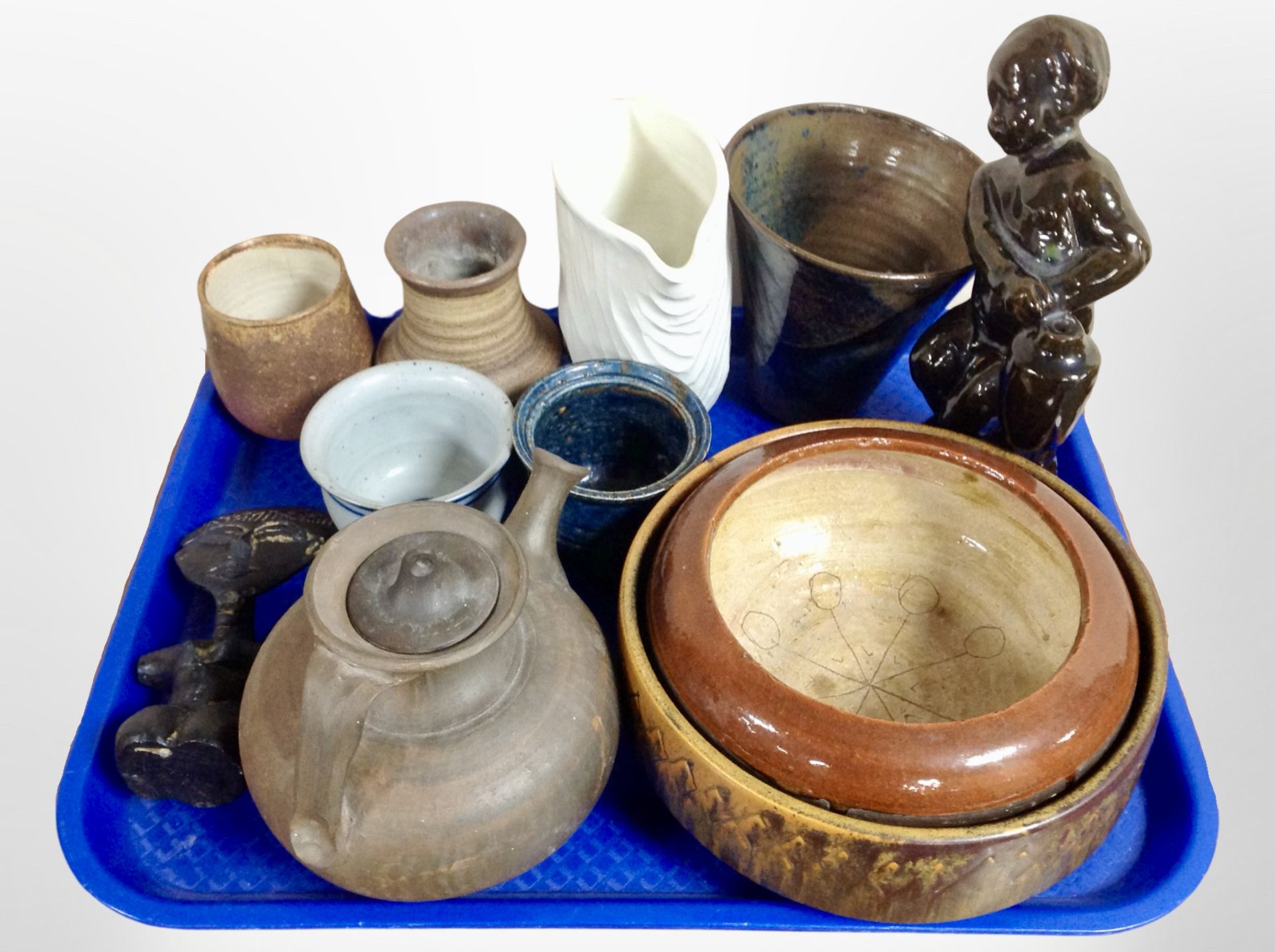 A group of 20th-century Danish studio pottery including teapot, figure of a boy, vessels.