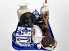 A tray of oriental wares including porcelain lidded vases, carved figures of Buddha,