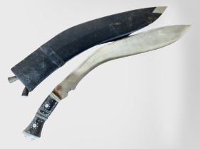 A large kukri knife in sheath, overall length 58cm.