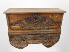 An early 20th-century oriental carved and painted elm chest, 128cm x 50cm x 99cm.