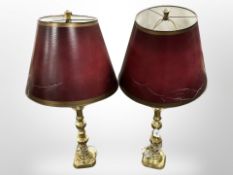A pair of brass candlesticks converted to table lamps,