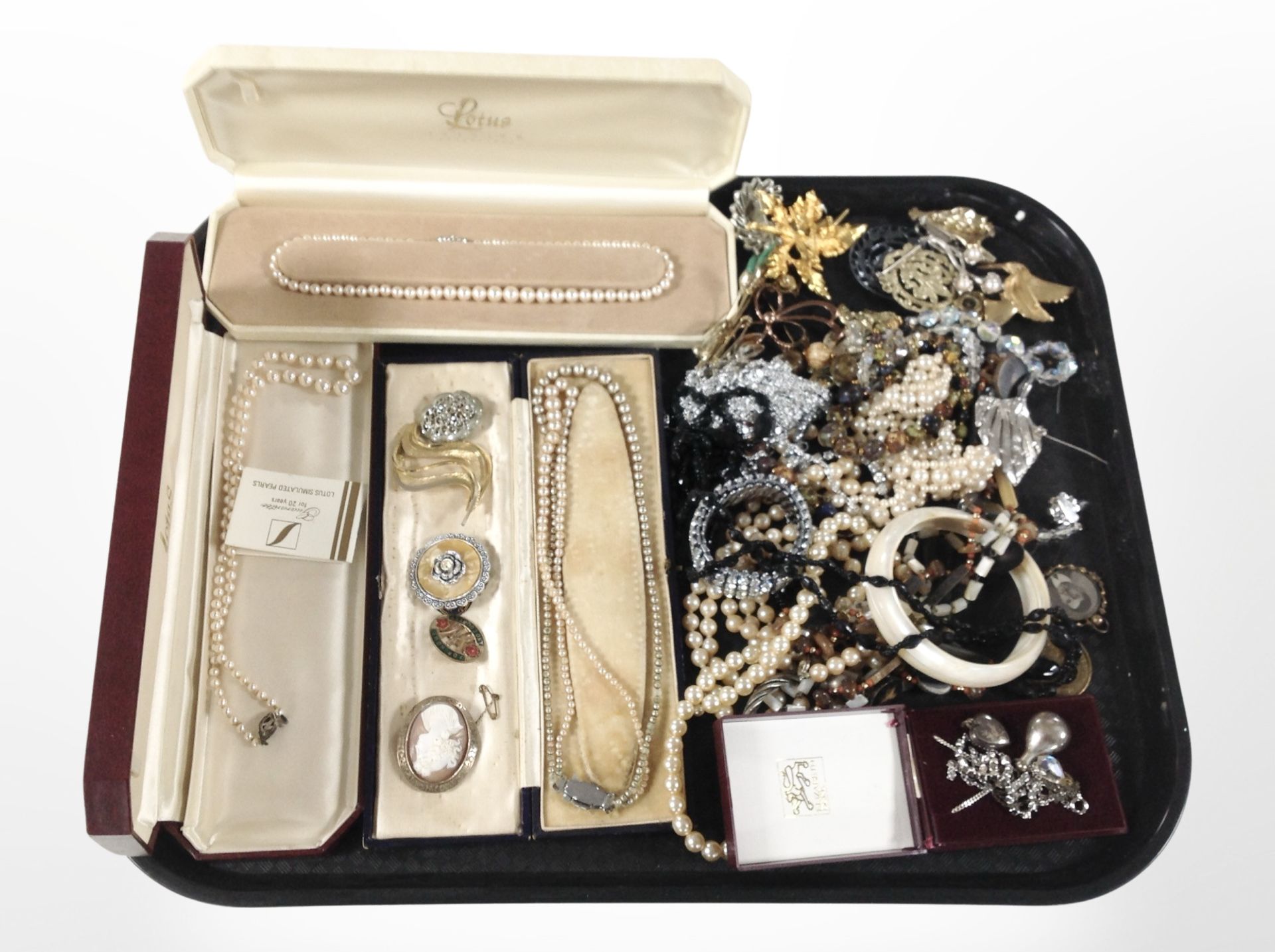 A group of silver and costume jewellery including heart locket, pendant, faux pearl necklaces,