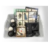 A group of framed postcards and cigarette cards, together with two pairs of field binoculars,
