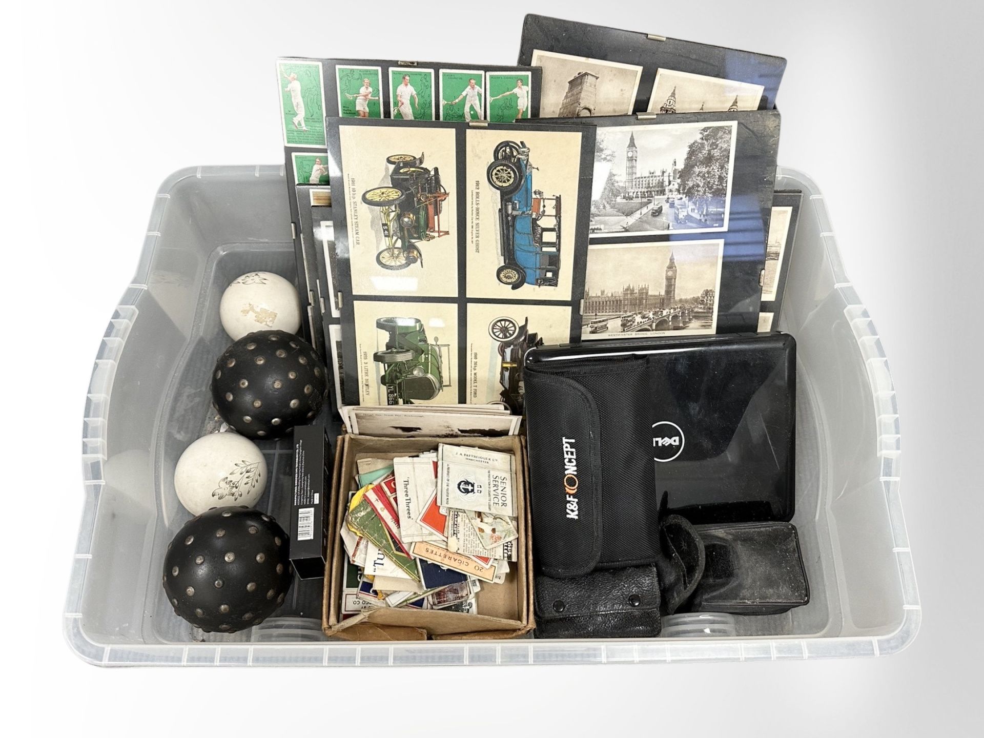 A group of framed postcards and cigarette cards, together with two pairs of field binoculars,