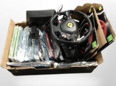 A box containing gaming steering wheel and pedals, tablet covers.