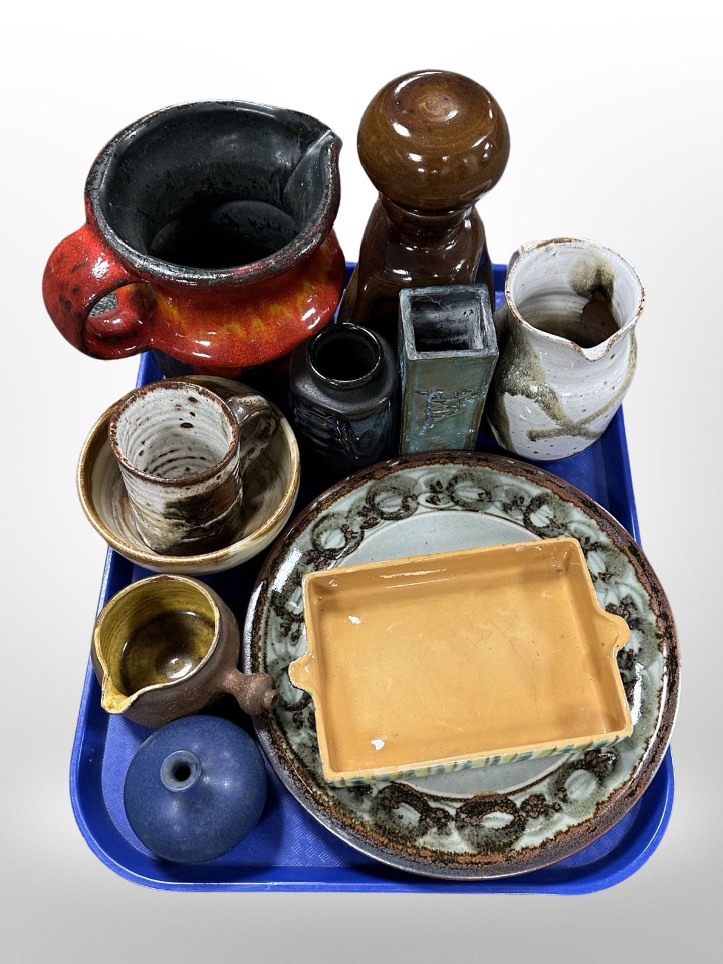 A group of 20th-century Danish studio pottery including red-glazed jug, shallow dishes, vases.