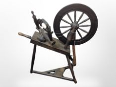 An early 20th-century stained beech spinning wheel.