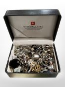 Swiss balance box containing over 100 costume rings, some silver.