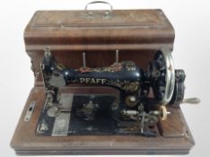 A Pfaff hand sewing machine in walnut case.