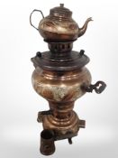 A copper-plated and engraved samovar and matching teapot.