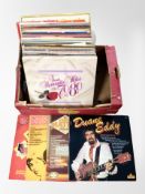 A box of vinyl LP records, compilations including the Bee Gees, Simon and Garfunkel, Elvis.