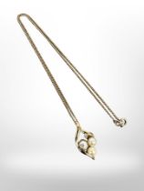 A 9ct yellow gold pendant set with two pearls and two small diamonds,