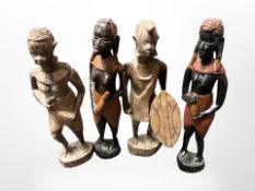 Four carved African figures.