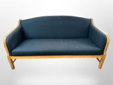 An early 20th-century Danish oak-framed three-seater settee in black upholstery,