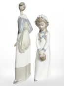 Two Nao figures depicting a lady holding corn and a child holding a basket.