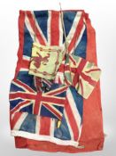 An antique British flag and four smaller examples.