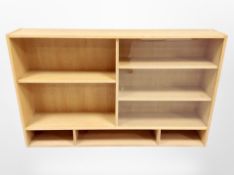 A Danish blonde oak sliding glass door bookcase, 130cm x 24cm x 80cm.