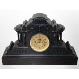 A 19th-century slate mantel clock with visible escapement to dial, height 35cm.