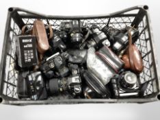 A crate of vintage cameras and lenses including Chinon, camera accessories, etc.