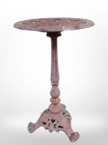 A 19th-century painted cast-iron plant stand on paw feet, height 50cm.