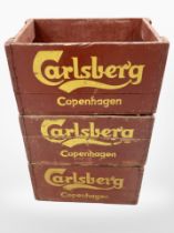 Three painted pine Carlsberg crates, each 47cm wide.