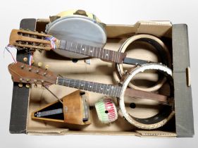 Two banjo ukelele bodies, a tamborine, a metronome, etc.