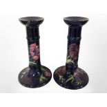 A pair of William John Moorcroft candlesticks, height 20.